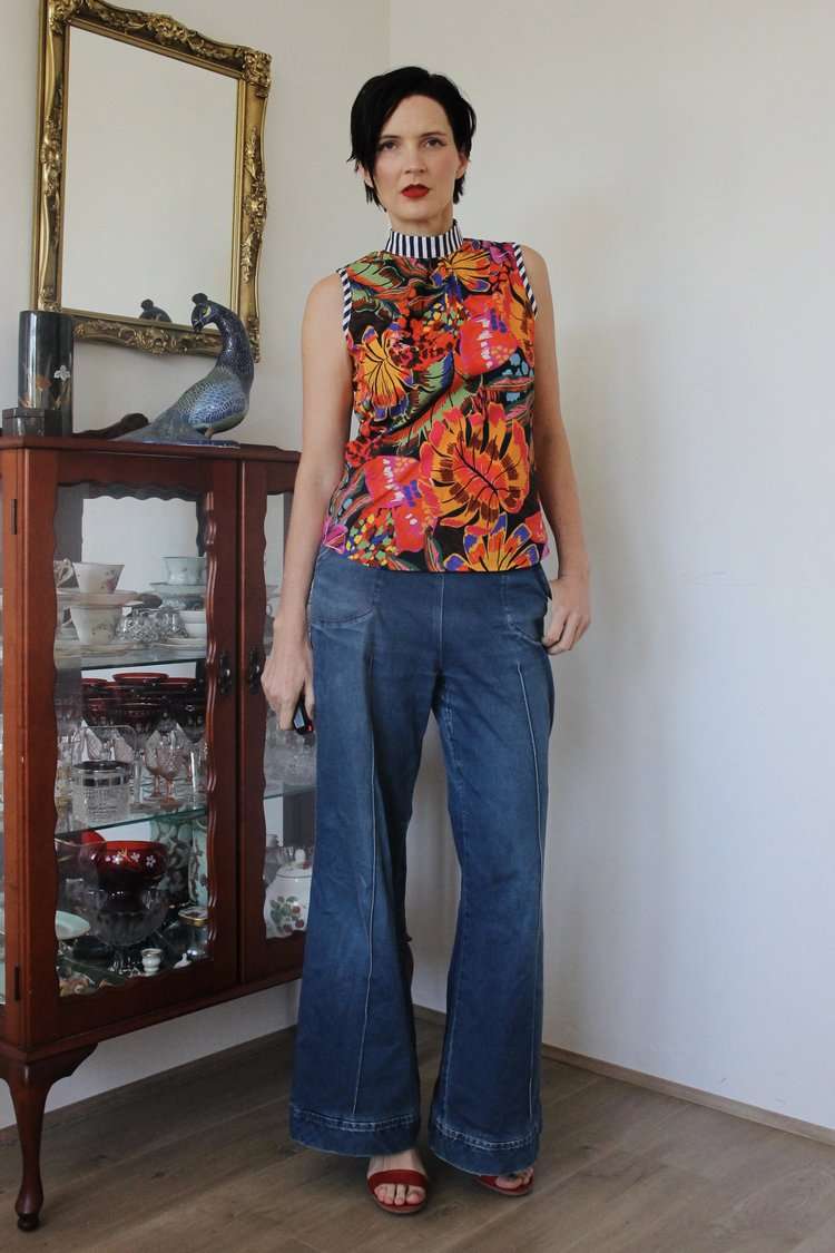 Sleeveless top with a bright tropical floral pattern and striped collar detail