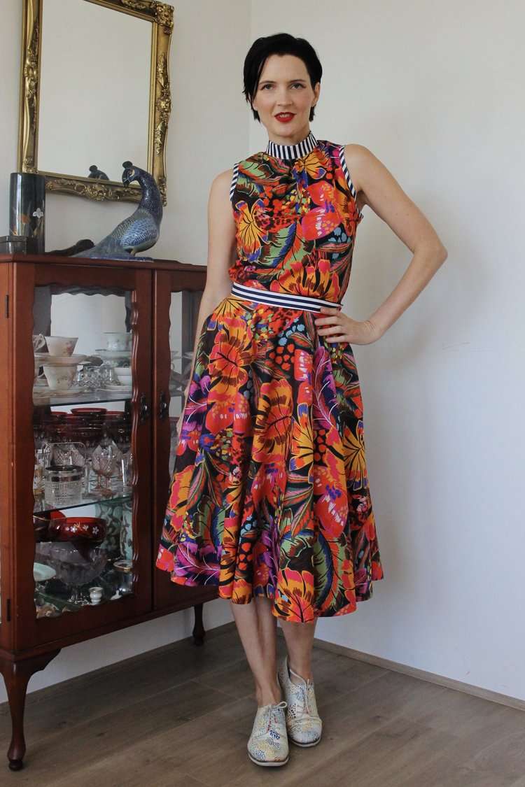 Floral patterned full-skirt dress in bold tropical colors.