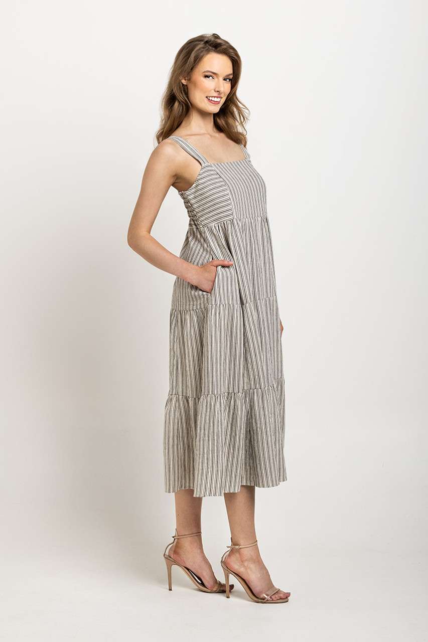 Light gray and white striped tiered dress with wide straps, designed with pockets and a timeless silhouette.