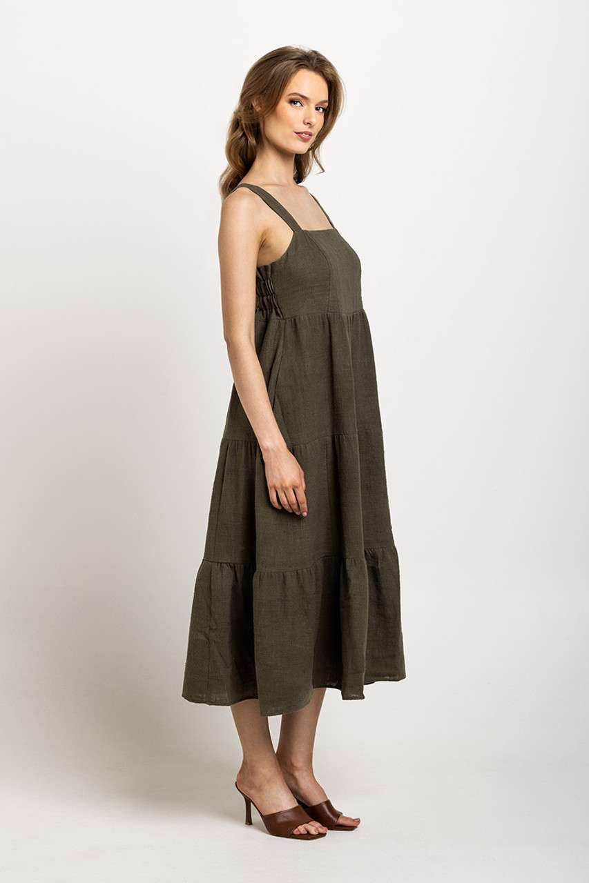 Deep olive tiered dress with a square neckline and pockets, offering a rustic, sustainable style.
