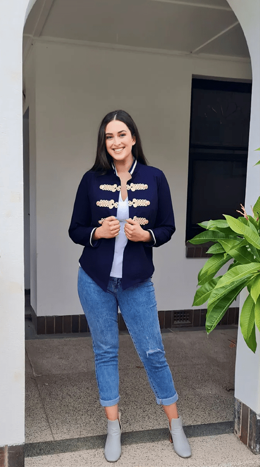 Twiggy Stretch Denim Jacket with Gold Brocade by Australian designer. A structured navy denim jacket adorned with intricate gold brocade detailing across the chest and cuffs.