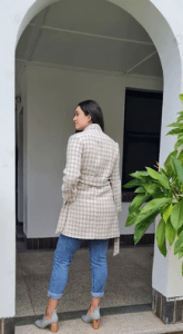 the Accolade Herringbone Coat in a taupe color with houndstooth pattern, creating a sophisticated and modern look