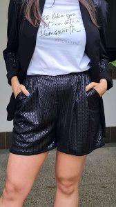 A pair of stylish black shorts with a subtle herringbone pattern with convenient side pockets, giving a chic yet comfortable look.