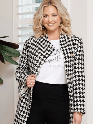 the Accolade Herringbone Coat in a classic black-and-white houndstooth pattern, creating a sophisticated and modern look
