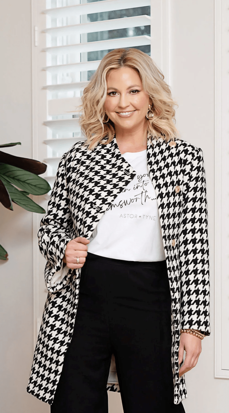 the Accolade Herringbone Coat in a classic black-and-white houndstooth pattern, creating a sophisticated and modern look