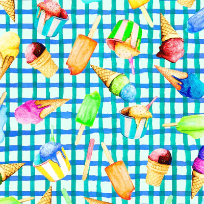 Woman wearing a green and blue dress with a colorful abstract print featuring fruit and ice-cream illustrations, styled for a playful, sunny-day look.