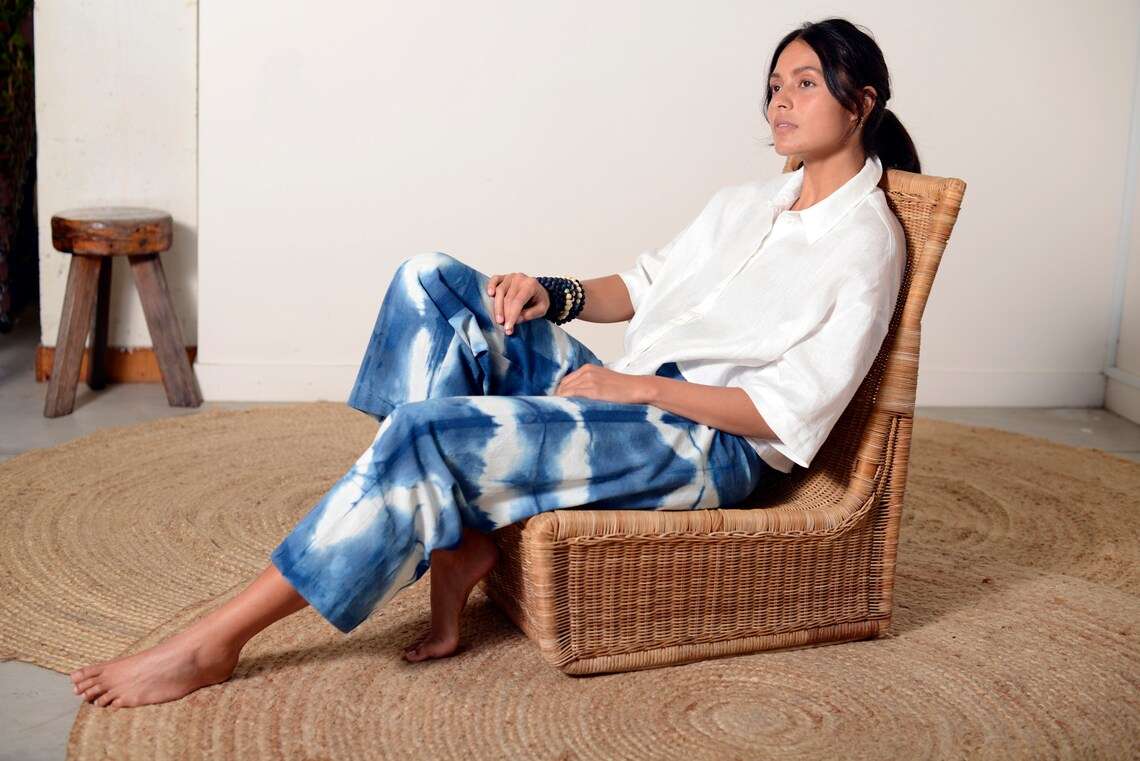 Blue and white Shibori-dyed pants with bold patterns, designed by Lava using plant-based natural textiles