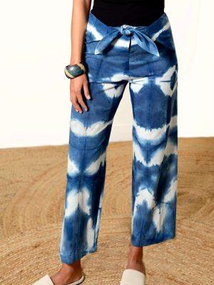 Blue and white Shibori-dyed pants with bold patterns, designed by Lava using plant-based natural textiles
