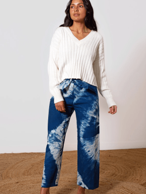 Blue Shibori-dyed pants with bold white patterns on natural textile, crafted by Lava using traditional Japanese resist dyeing techniques