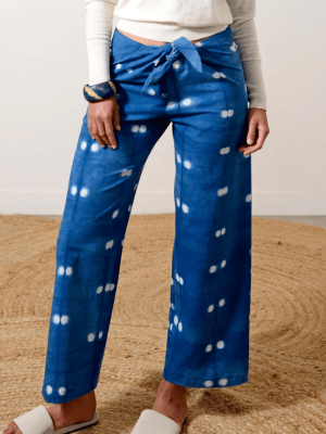 Blue Shibori-dyed pants with small white dots, hand-dyed by Lava on organic cotton fabric