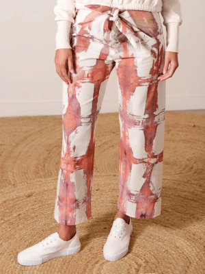 Rust and white grid-patterned pants using ice dyeing techniques by Lava, made from eco-friendly fabric