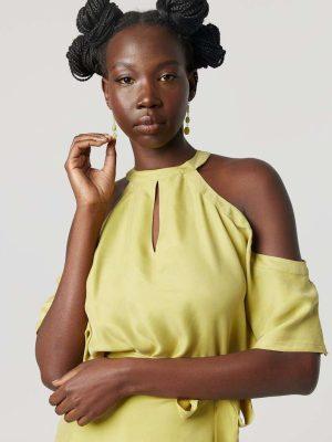 Yellow halter-neck dress: Minimalist cold-shoulder design with a waist tie for sustainable everyday elegance.
