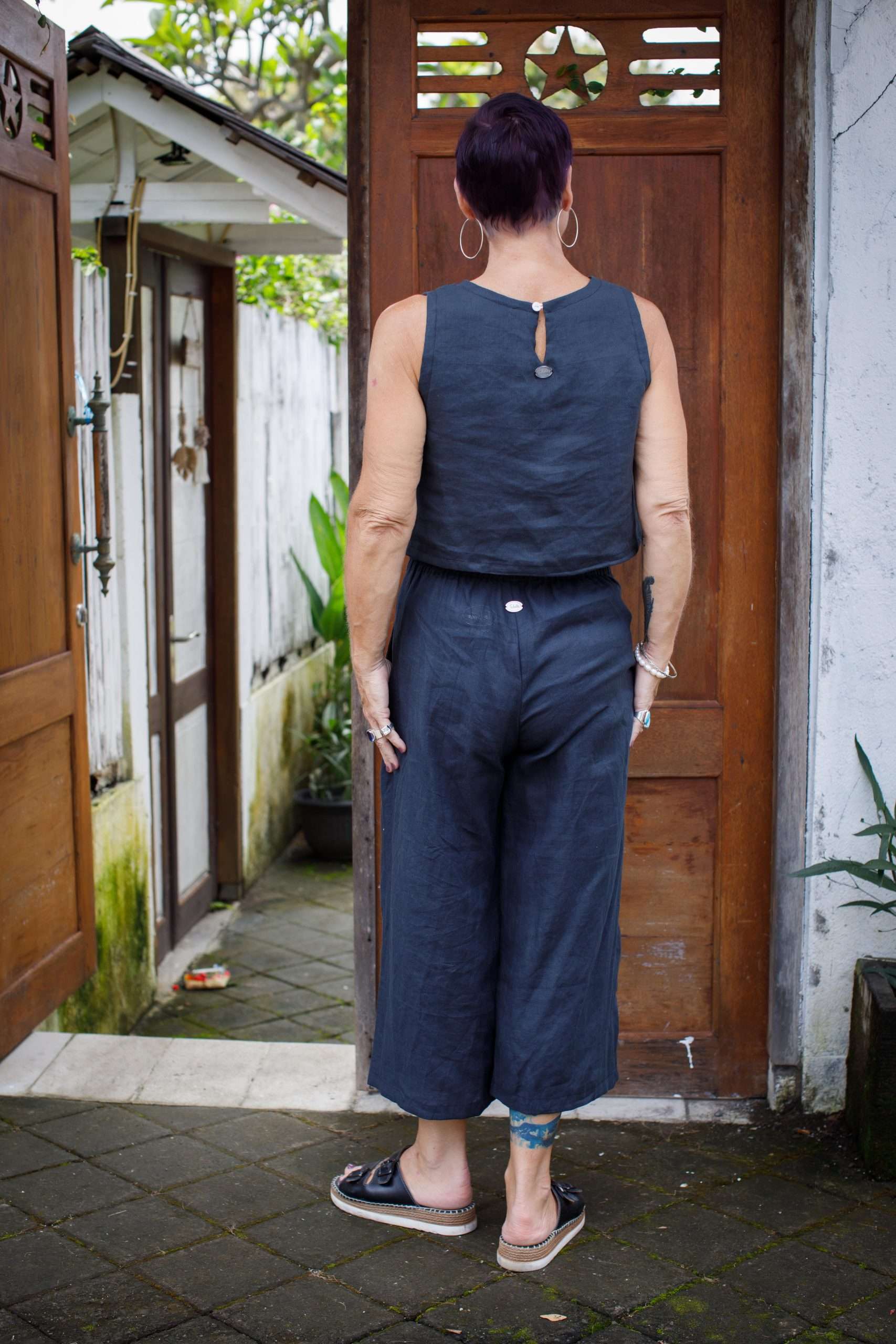 indigo linen top middle-aged woman showing back of sleeveless linen top
